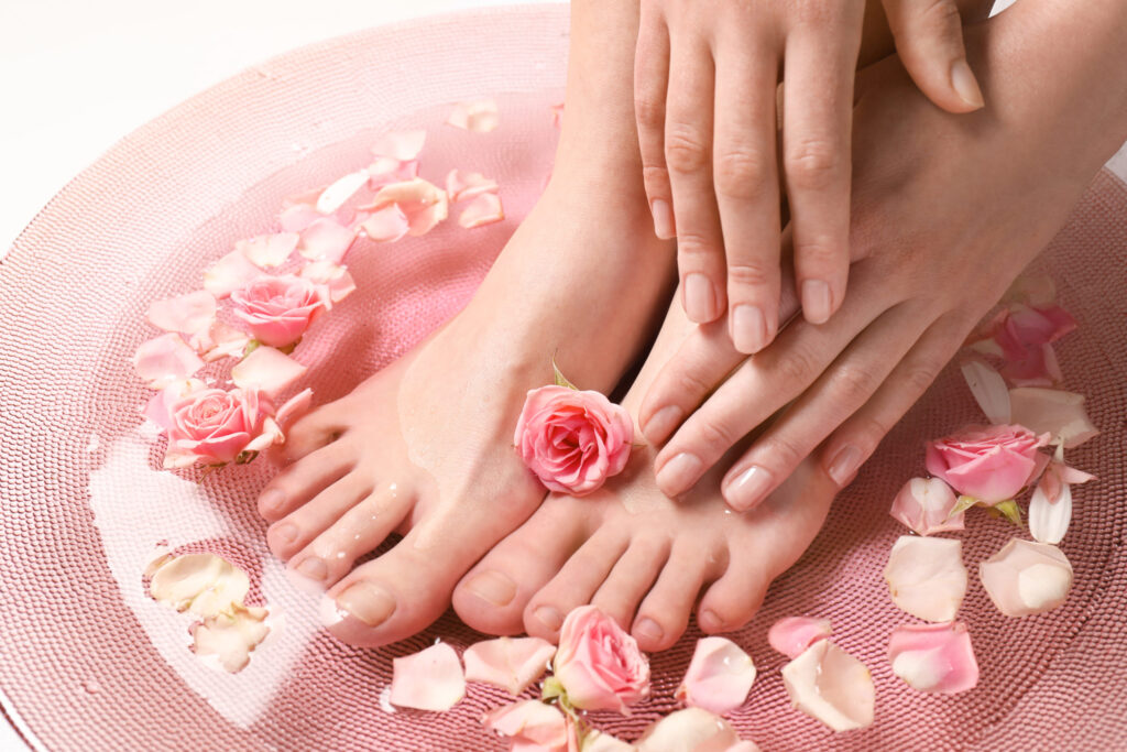 Young woman undergoing spa pedicure treatment in beauty salon, closeup